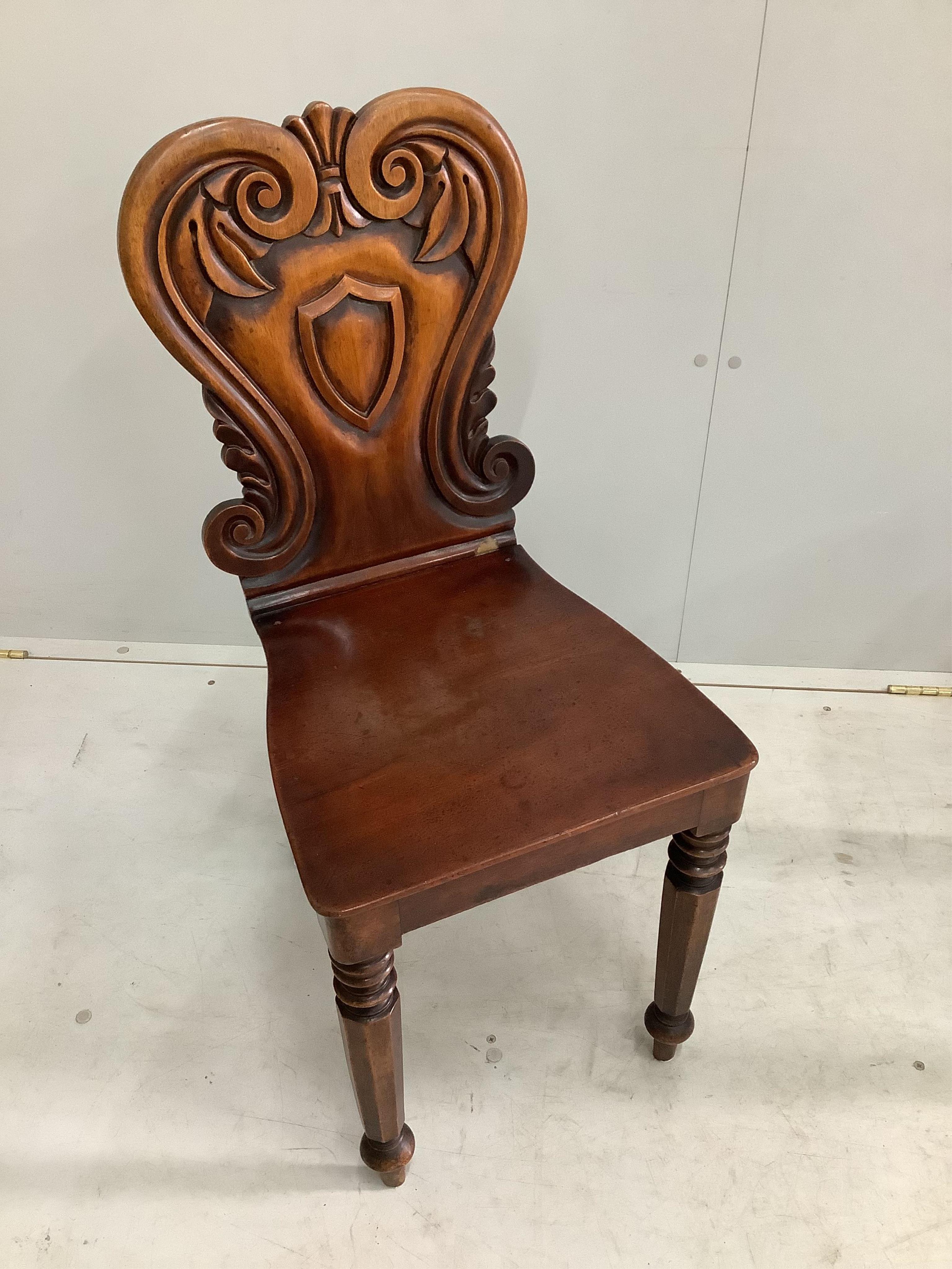 A pair of Victorian mahogany hall chairs, width 37cm, height 84cm. Condition - fair